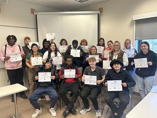 group of people holding certificates